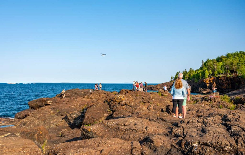 Black rocks presque isle cliff jumping looking at plane