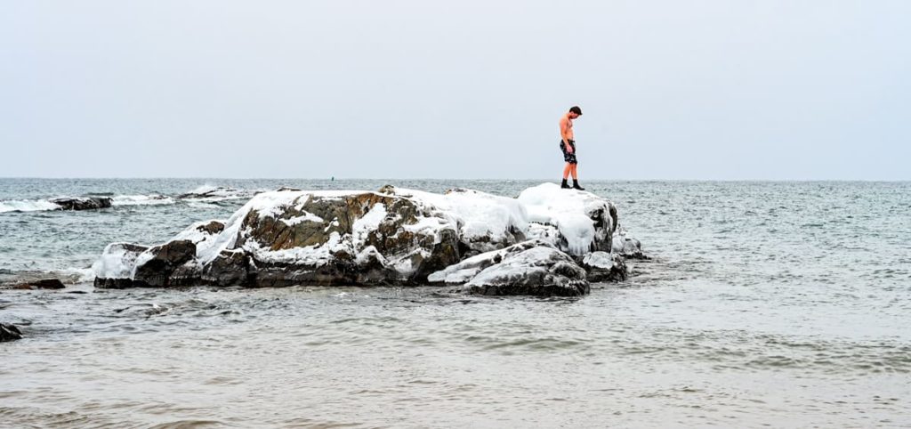 winter swimming in lake superior in Marquette on icy rocks